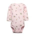Light pink long sleeve bodysuit with whimsical print of green plants, pink flowers, and grey birds