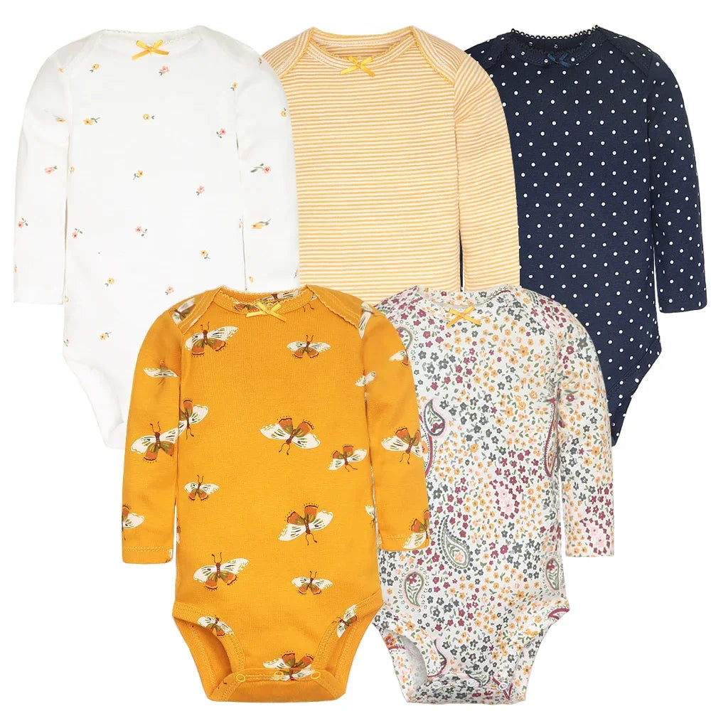 Warm neutral tone collection of five long-sleeve baby bodysuits featuring tiny yellow flowers, yellow-white stripes, navy