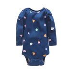 Navy romper with scattered colorful icons including pizza, hearts, stars, and cat faces