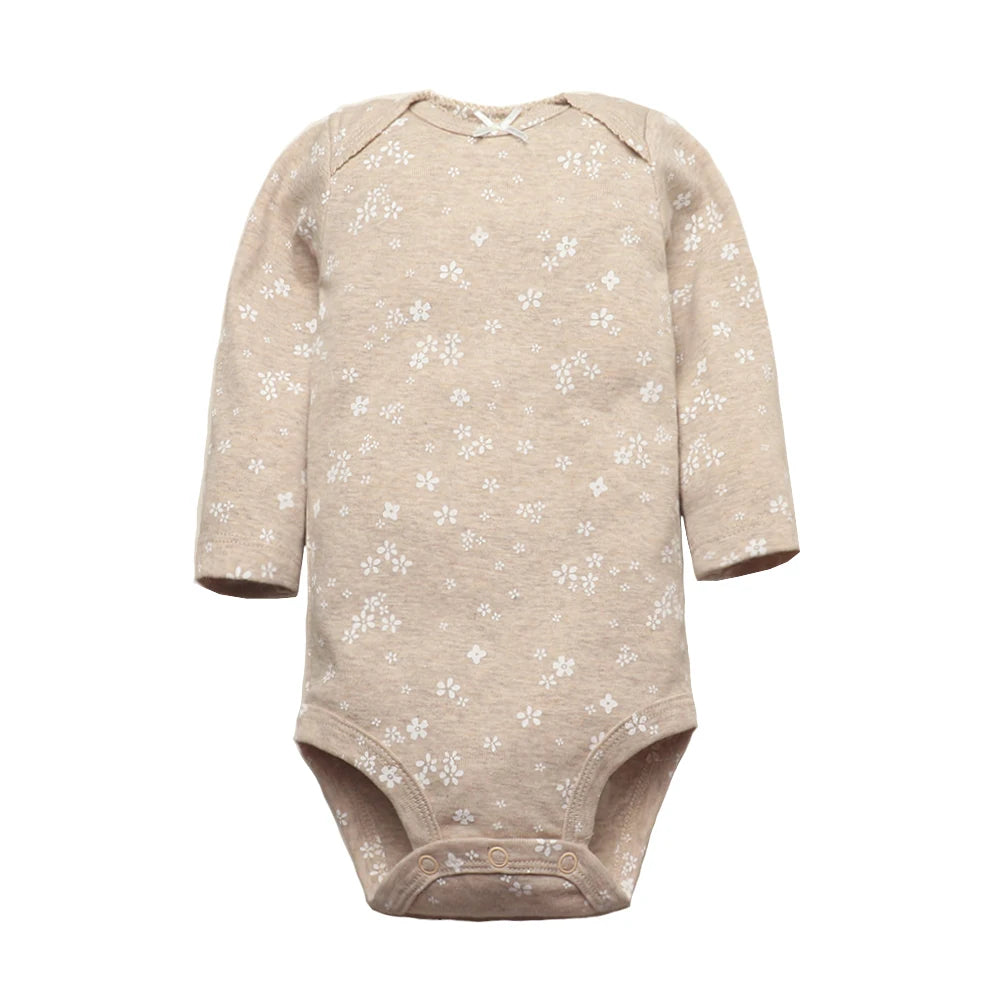 Beige heathered long sleeve bodysuit with scattered white floral print, back bow detail, and bottom snaps