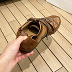 Rear view of brown casual sneaker highlighting padded collar and suede heel counter texture