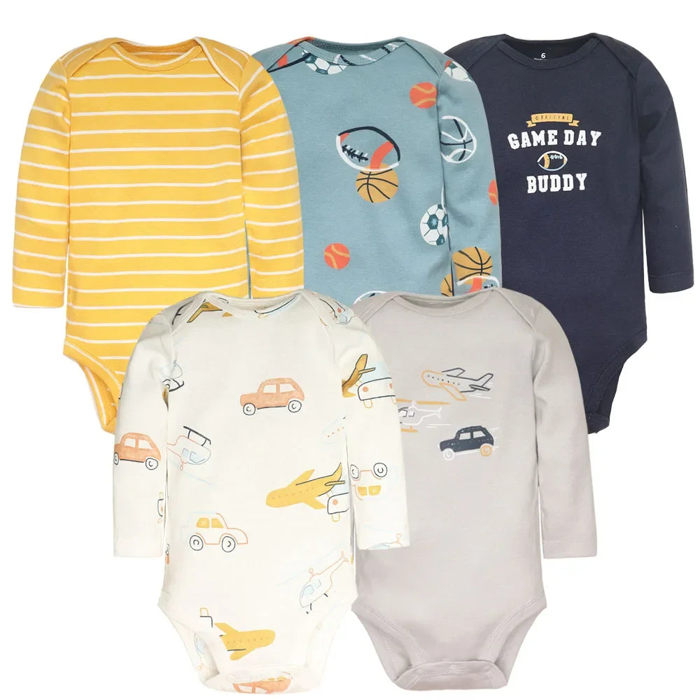 Sports-themed five-piece baby bodysuit set with yellow stripes, multi-ball print, navy 'Game Day Buddy' text, vehicle