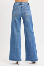 Back view of wide-leg jeans displaying patch pockets, centered seam, and black waistband label maintaining structured shape