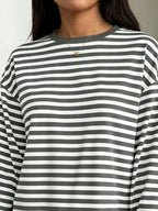 Grey and white striped t-shirt detail featuring ribbed collar, dropped shoulder seam, and soft stretchy fabric texture