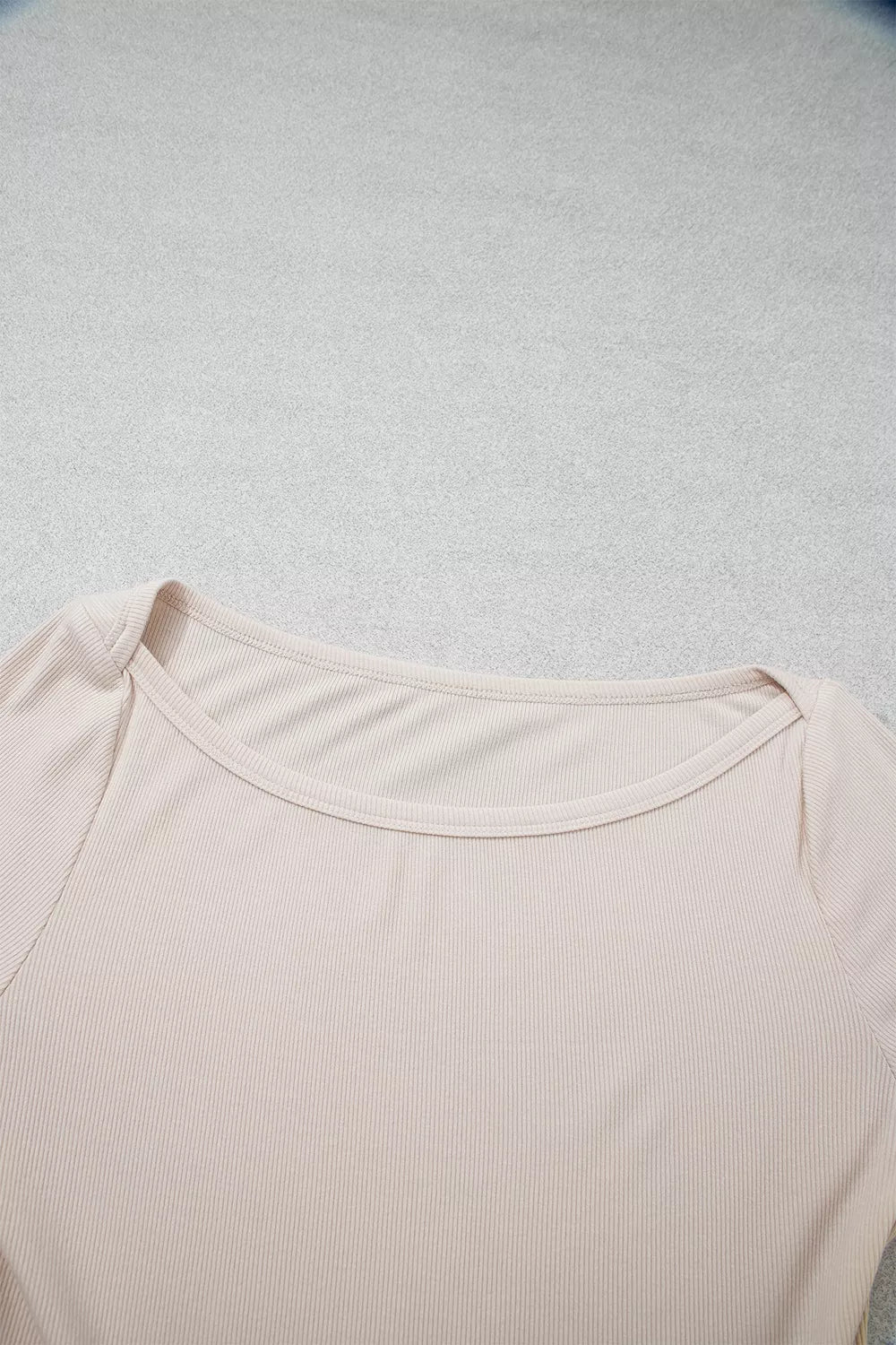 Detail shot of wide rounded scoop neckline with neat ribbed binding stitching