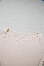 Detail shot of wide rounded scoop neckline with neat ribbed binding stitching