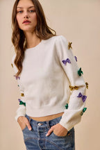 SO ME Sweater Knit Top Mardi Gras Glitter Bow Ribbon Ivory b4f4e6519e64414cadb6bc1f729e7abe-Max-Origin Trendsi