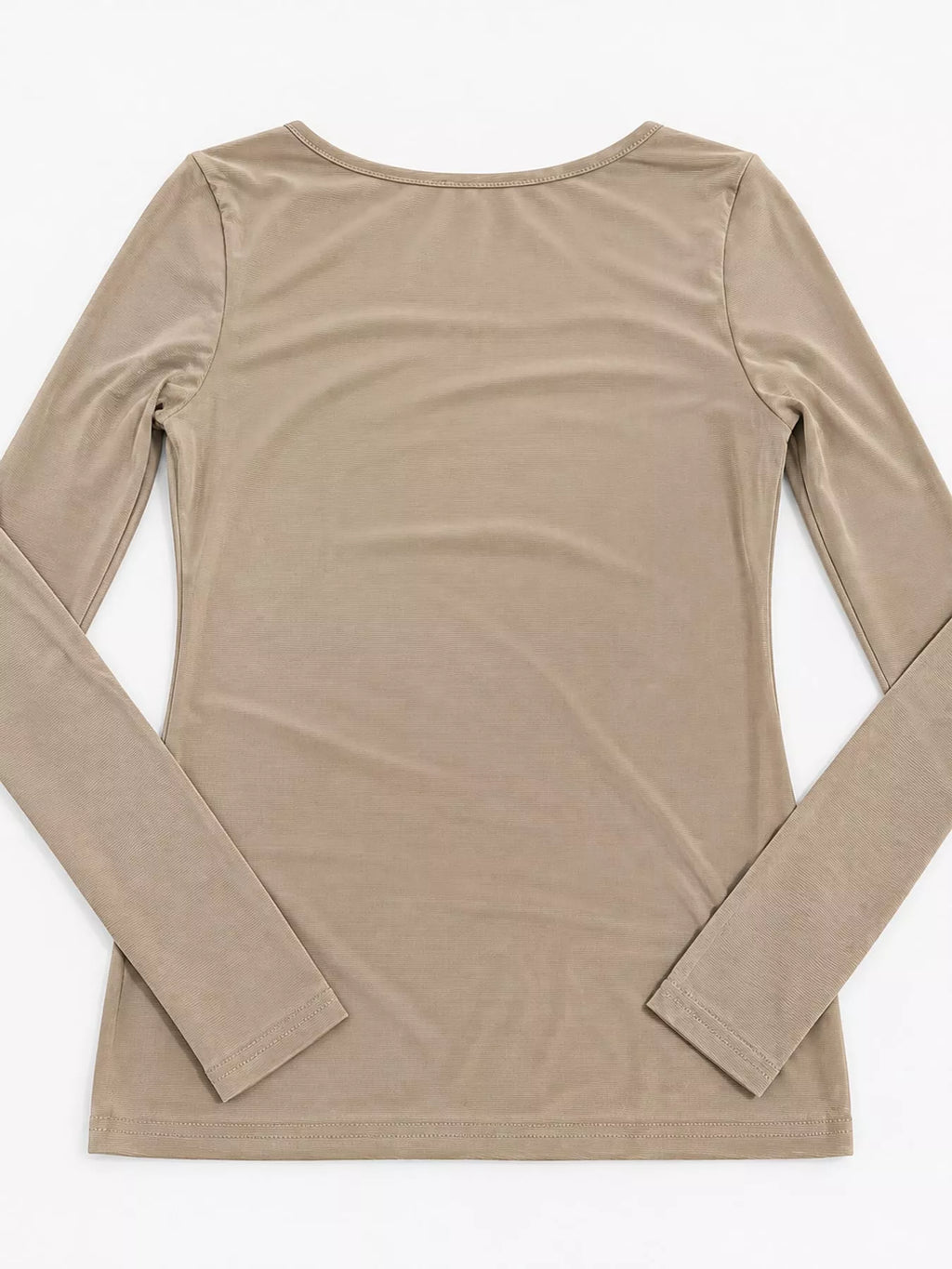 Back view of beige sheer mesh top laid flat showing rounded neckline and ribbed hem stitching