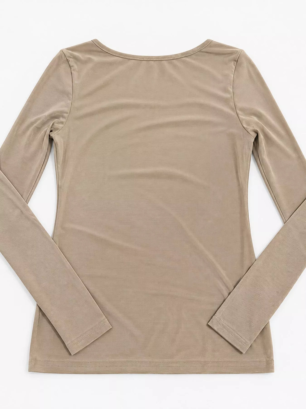 Back view of beige sheer mesh top laid flat showing rounded neckline and ribbed hem stitching
