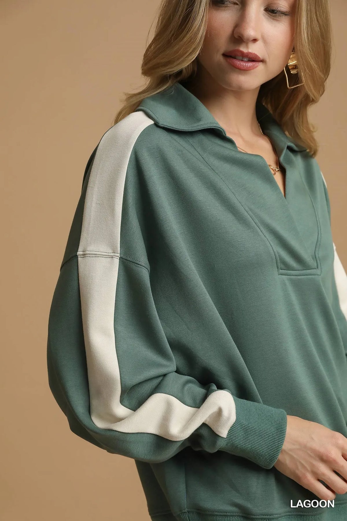 Close-up of soft cotton blend fabric texture, structured collar, and stitching details