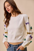 SO ME Sweater Knit Top Mardi Gras Glitter Bow Ribbon Ivory c1897f8f610840d0a520df3af6dbae86-Max-Origin Trendsi