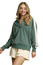 Front view of sage green quarter zip pullover with white accents and relaxed fit