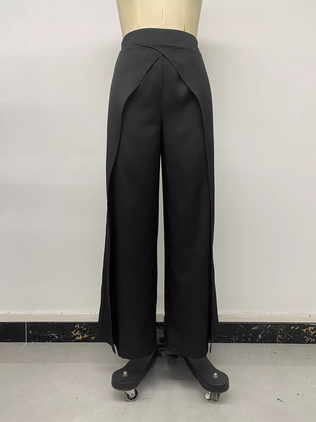 Front view of black high-waisted pants with draped V-shape overlap panel detail
