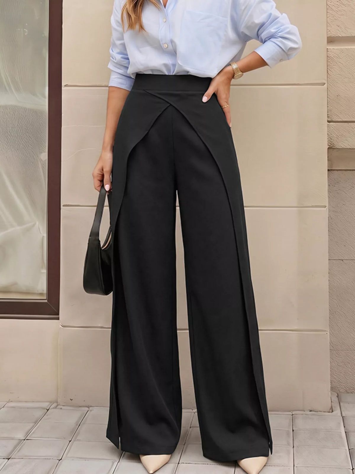 Black wide-leg pants with overlap front detail styled with a light blue shirt and nude heels