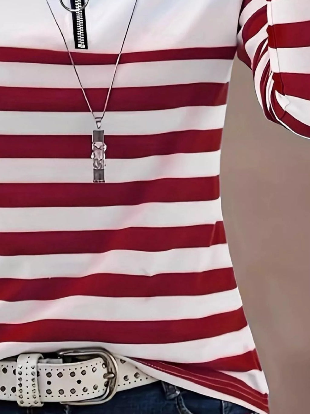 Mid-section of red and white striped shirt showing fabric fit and pendant necklace