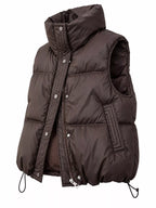 Three-quarter angle of brown insulated vest showing padding volume and hardware