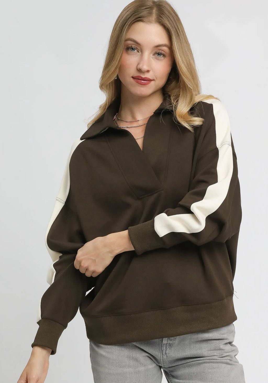 Espresso brown oversized polo sweatshirt with wide cream stripes on sleeves and V-neck placket