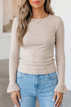 Beige ribbed long sleeve top with eyelet lace cuffs worn by a model in jeans