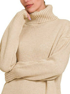 Close-up of beige ribbed turtleneck collar and textured knit fabric on long sleeves