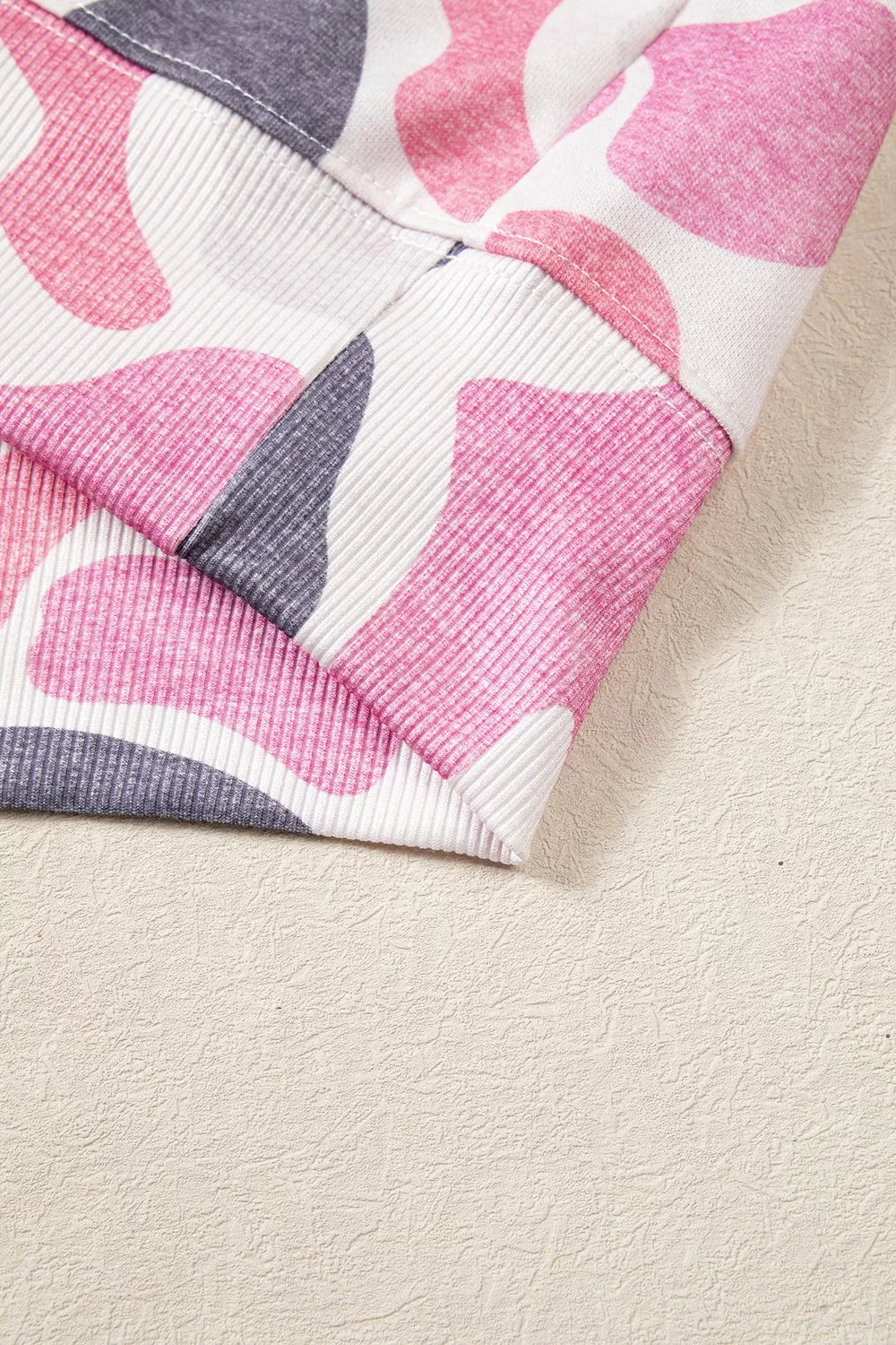 Macro shot of bottom hem showing ribbed knit construction and precise stitching on elastic edge