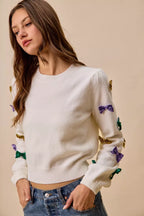 SO ME Sweater Knit Top Mardi Gras Glitter Bow Ribbon Ivory ea00825aa5bf4cbe9ea4206a79b1f579-Max-Origin Trendsi