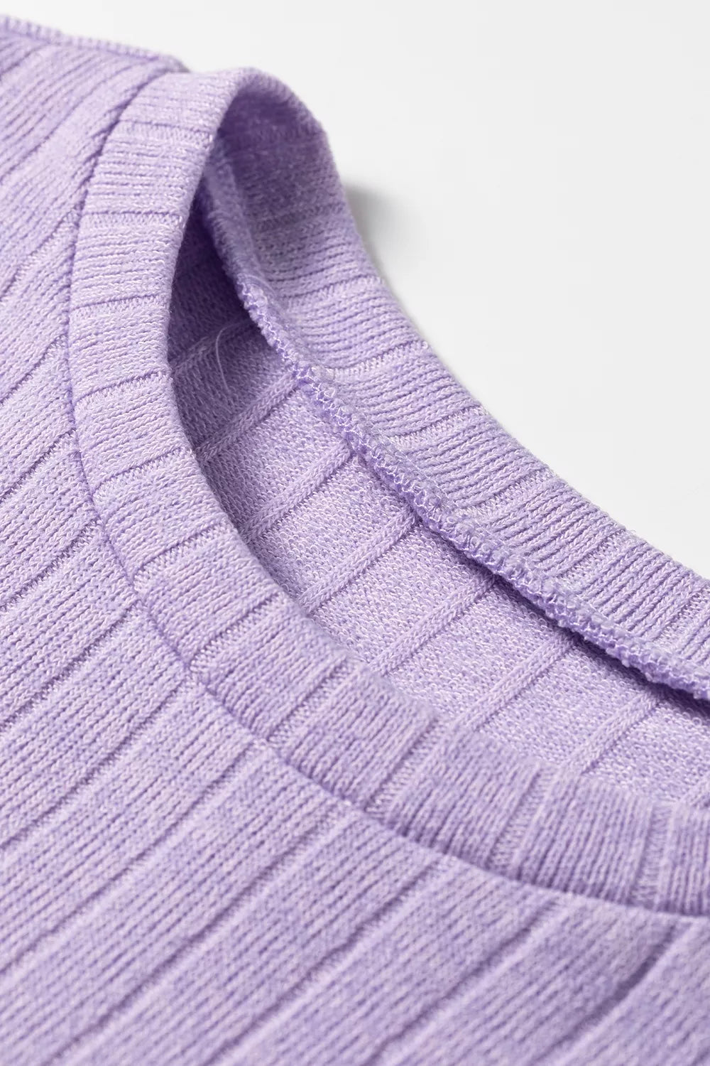 Macro shot of lavender ribbed fabric neckline showing soft weave and elasticated collar binding