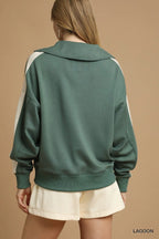 Back view of plain sage green sweatshirt with white contrast stripe over shoulder seam