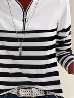 Side view of fitted black and white striped shirt with horizontal pattern and belt