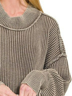 Detailed view of double-layered neckline construction and seam on dropped shoulder of mocha ribbed knit top