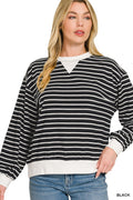 Close-up of black and white striped sweatshirt with crew neck, white V-panel, ribbed cuffs, and hem against white background
