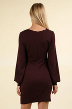 Back view of maroon mini dress showing vertical spine seam and tapered long sleeves