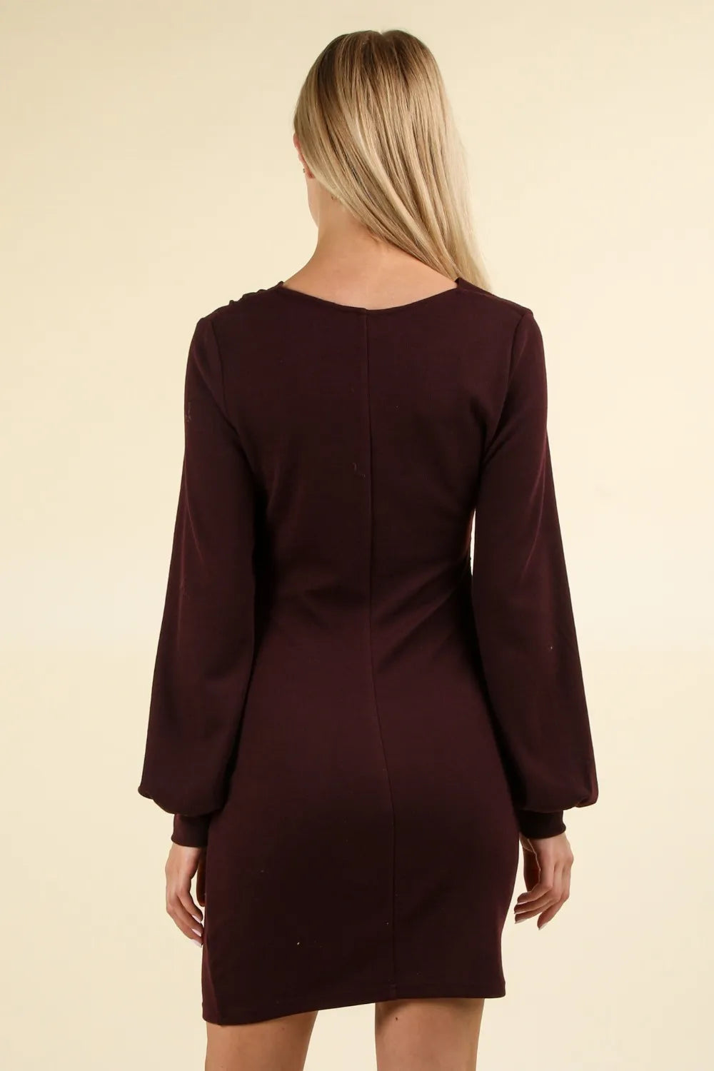 Back view of maroon mini dress showing vertical spine seam and tapered long sleeves