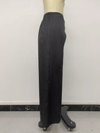 Side profile of black trousers on mannequin showing smooth vertical drape to hem